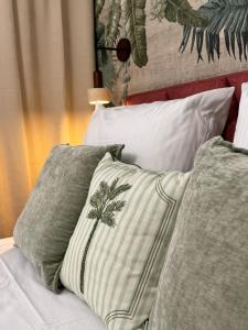 a bed with green and white pillows on it at Terra Rosa in Radom