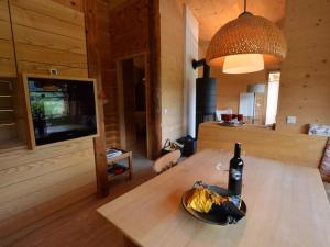 a bottle of wine and a bowl of bananas on a table at Mondholz in Niedernsill
