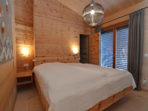 a bedroom with a bed in a wooden room at Mondholz in Niedernsill
