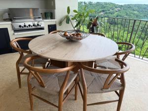 a wooden table with chairs and a bowl on top at El Sueo in Nacascolo