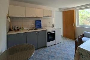 a kitchen with a sink and a stove at Apartments with parking space Zaglav, Dugi otok - 11924 in Zaglav