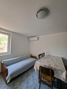 a room with a bed and a table and a window at Apartments with parking space Zaglav, Dugi otok - 11924 in Zaglav