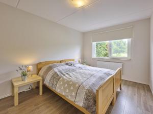 a bedroom with a bed and a window at t Katreel in Rietmolen