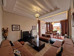 a living room with a couch and a table at bled ghazal in Marrakesh