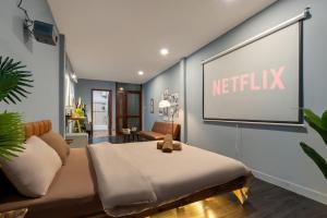 a living room with a netflix sign on the wall at Rose House in Ho Chi Minh City