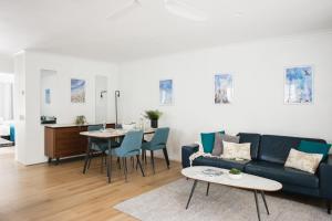 a living room with a couch and a table at A Noosa River gem, central and family friendly in Noosaville