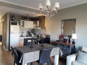 a kitchen with a table with chairs and a dining room at departamento en parque Necochea in Necochea +2 photos