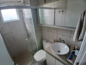 a bathroom with a toilet and a sink and a shower at Apartamento Familia Granja Viana in Carapicuíba