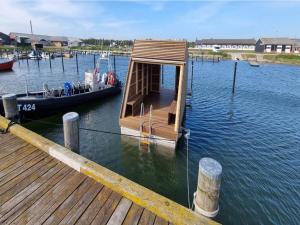 a small boat sitting on the water next to a dock at Nice property Swimming pool, Gym in Mellet