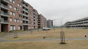 a car parked in a parking lot next to buildings at Departamento Los Pasos in Rosario