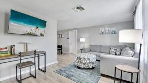 a living room with a couch and a table at Pool! BBQ ! Sleeps 8PPL TV's King Bed in Port Richey