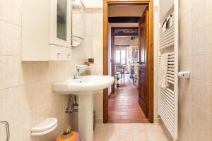a bathroom with a sink and a toilet and a hallway at Casa Vacanze in pietra del '700 in San Leo +21 photos