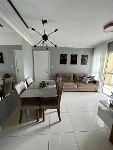 a living room with a table and a couch at Apartamento próximo a Orla de Atalaia in Aracaju