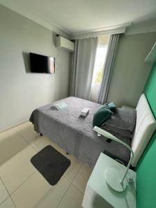 a hospital room with a bed and a couch at Apartamento próximo a Orla de Atalaia in Aracaju
