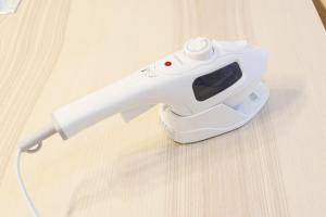a white electric hair dryer sitting on a wooden table at Dori Dori House Ebisu in Tokyo +26 photos