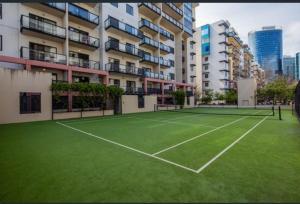a tennis court in front of a building at City CBD Retreat in Perth