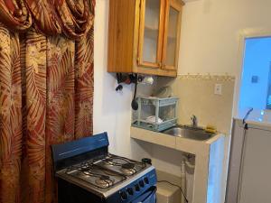 a kitchen with a stove and a sink at Montego Bay Multicultural Villa Guesthouse in Montego Bay