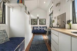 a tiny house with a kitchen and a sink at Tiny Hideaway at Cloverhills by Tiny Away in Newham