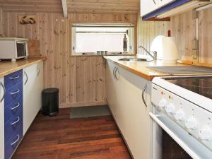 a kitchen with a sink and a stove top oven at 6 person holiday home in Storvorde-By Traum in Storvorde +25 photos