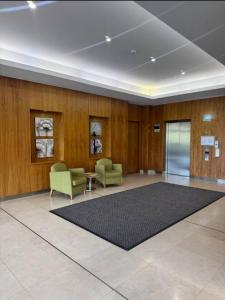 a lobby with two chairs and a rug at City CBD Retreat in Perth +7 photos