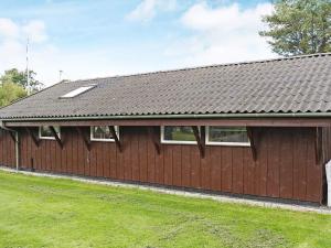 a brown building with windows and a roof at 6 person holiday home in Storvorde-By Traum in Storvorde