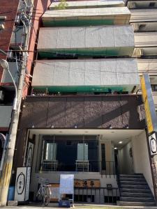 a building with a balcony and stairs in front of it at Liaison Apartment Shinsaibashi in Osaka +25 photos