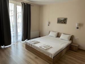 a bedroom with a bed with two towels on it at The Hillside Villa in Ognyanovo +45 photos