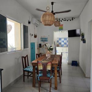 a dining room with a wooden table and chairs at House 50 meters from the beach in Progreso