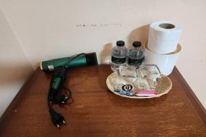 a pen and some water bottles and glasses on a table at My Pumpkin Bungalow Krabi in Krabi town