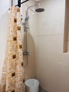 a shower in a bathroom with a shower curtain at WV 29 Homey Hideout in Iloilo City +20 photos