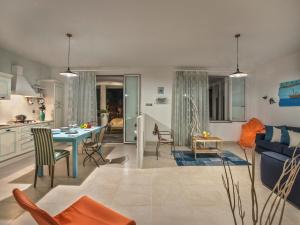 a kitchen and living room with a table and a couch at Spacious Villa with Pool in Tavullia