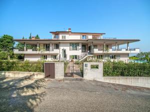 a large white house with a gate in front of it at Tranquil Escape in Tavullia in Tavullia