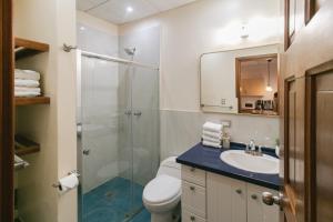 a bathroom with a shower and a toilet and a sink at Bocas Condos - Studio for 4 in Bocas del Toro +44 photos