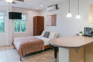 a bedroom with a bed and a table in it at Bocas Condos - Studio for 4 in Bocas del Toro
