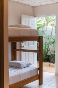 two bunk beds in a room with a patio at Bocas Condos - Studio for 4 in Bocas del Toro