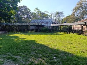 a large building in a field with a grass yard at Eco hotel Irapay in Puerto Alegría