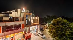 a building with a car parked in a parking lot at Hotel Ramay Palace in Ayodhya
