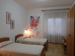 Ένα ή περισσότερα κρεβάτια σε δωμάτιο στο Sa 'E Jana