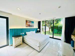 a bedroom with a large bed and large windows at Oceanami Villa Resort 3 phòng ngủ, 3 phòng tắm - Đầy đủ tiện nghi - Bếp nấu - BBQ - Hồ bơi 2000 m2 - Long Hải Beach in Long Hai +32 photos