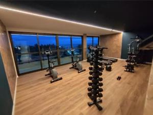 a gym with several tread machines in a room at Flat08 Tamandaré Carneiros in Tamandaré