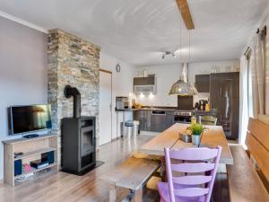 a living room with a wooden table and a stove at Chalet in Leogang near Ski Lifts in Leogang