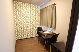 a small dining room with a table and chairs at Kyostay Iroha Toji Annex in Kyoto