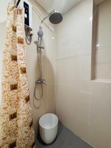 a bathroom with a toilet and a shower at WV 29 Your Warm City Escape in Babuy +14 photos