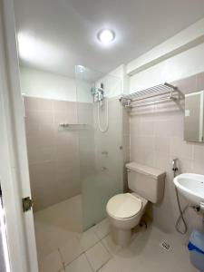 a bathroom with a shower and a toilet and a sink at Prime City Location - 3 Bedroom Unit in Lapu Lapu City