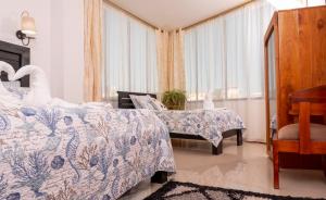 a bedroom with two beds and a chair and a window at All INCLUSIVE GALAPAGOS & BEYOND 2 in Puerto Ayora +40 photos