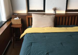 a bedroom with a bed with a wooden head board at Gyeongju Stayrophy Eupseong Branch in Gyeongju