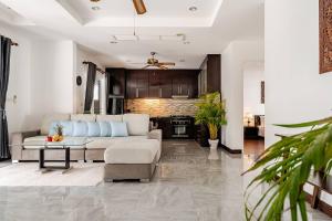 a living room with a couch and a table at Cozy Pool Villa near Kamala - 850 meter to the beach in Kamala Beach