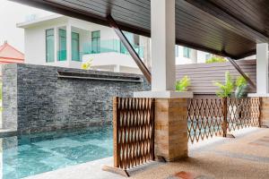 a swimming pool in front of a house at Cozy Pool Villa near Kamala - 850 meter to the beach in Kamala Beach