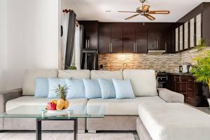 a living room with a white couch with blue pillows at Cozy Pool Villa near Kamala - 850 meter to the beach in Kamala Beach