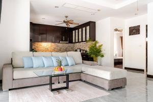 a living room with a couch and a table at Cozy Pool Villa near Kamala - 850 meter to the beach in Kamala Beach +50 photos